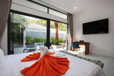 a bedroom with a bed with a towel on it at Andaman Paradise 1 - Luxury 3-Bedrooms Pool Villa in Rawai Beach