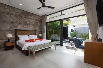 a bedroom with a bed and a sliding glass door at Andaman Paradise 1 - Luxury 3-Bedrooms Pool Villa in Rawai Beach