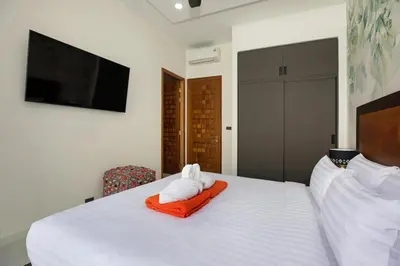 a bedroom with a bed with two towels on it at Andaman Paradise 1 - Luxury 3-Bedrooms Pool Villa in Rawai Beach
