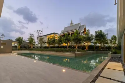 a swimming pool in front of a building at C231 Brand-New 1BR Prime Spot Pool&Gym Near Beach in Bang Tao Beach