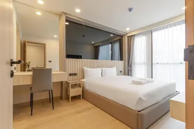 a bedroom with a bed and a desk and a mirror at C226 Brand-New Top Location Near Beach Clubs in Bang Tao Beach