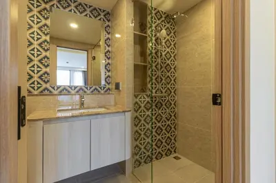 a bathroom with a shower with a sink and a mirror at C226 Brand-New Top Location Near Beach Clubs in Bang Tao Beach