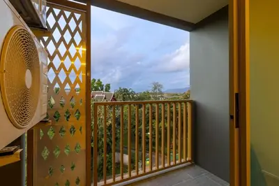 a balcony with a large window with a view at C227 Brand New Condo Near Top Phuket Beach Clubs in Bang Tao Beach