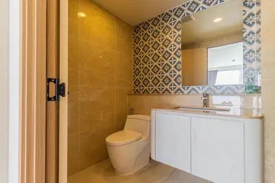a bathroom with a toilet and a sink and a mirror at C228 Brand New Condo Near Beach & Prime Location in Bang Tao Beach