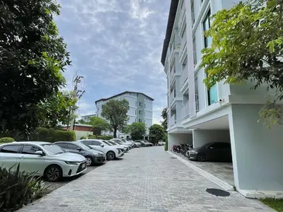 a row of cars parked next to a building at The Title Rawai Aparthotel by HSS in Rawai Beach