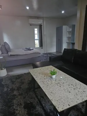 a living room with a couch and a table at Tropical Hideaway Close to the Beach in Ban Thalat Choeng Thale
