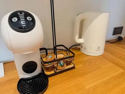 a hair dryer sitting on a wooden floor next to a blender at FAMILY HOMES - Brand New 2BDRM Poolside Apartment in Phuket