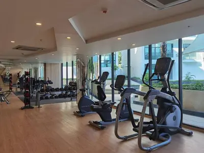 a gym with treadmills and ellipticals in a building at Stylish studio on Rawai beach in Rawai Beach