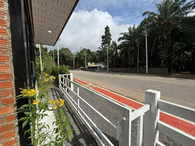 a white fence on the side of a road at Guitar Thai Style Pool House in Ao Nang Beach
