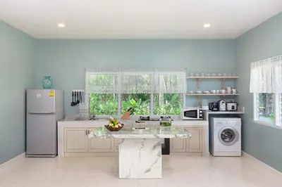 a kitchen with a marble counter top and appliances at Fisherman Way Beach Villa in Rawai Beach