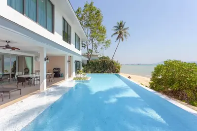 an infinity pool in the backyard of a villa at Fisherman Way Beach Villa in Rawai Beach