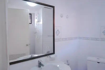 a bathroom with a mirror and a sink at xx GO INN Patong Beach Phuket - โกอินน์ ป่าตอง in Patong Beach