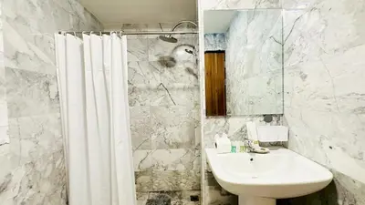 a white bathroom with a sink and a shower at Cozy condo maikhao Phuket in Ban Mai Salae
