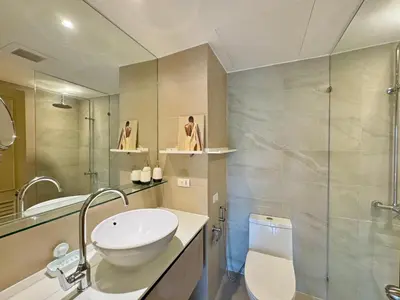 a bathroom with a sink and a toilet and a shower at Cozy 1 BR Allamanda Laguna Phuket in Laguna Phuket