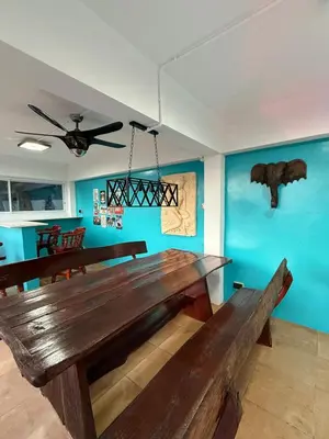 a large wooden table in a room with blue walls at Tropical 2BR Villa Sunset & Sea View in Karon Beach