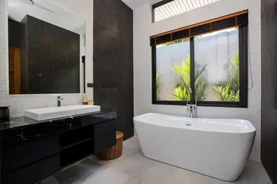a bathroom with a tub and a sink and a window at Andaman Paradise 2 Luxury 4 Bedrooms Pool Villa in Rawai Beach