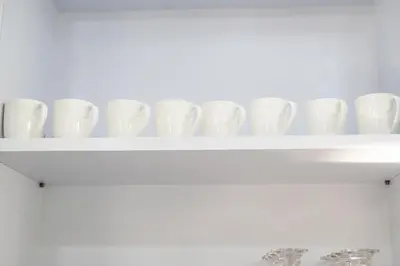 a row of white cups sitting on a shelf at Andaman Paradise 3 - Luxury 4 Bedrooms Pool Villa in Rawai Beach