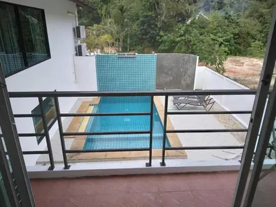 a balcony with a swimming pool on top of a house at Hillside 3 Bedroom Vacation Home with Pool in Kamala Beach