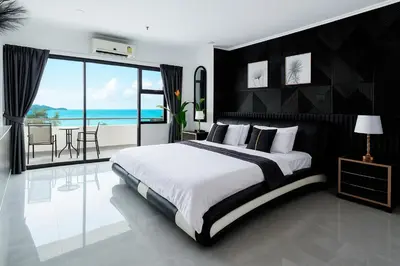 a bedroom with a large bed with a view of the ocean at Patong Tower 2 Bedroom Sea View 8 Floor in Patong Beach