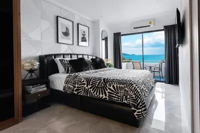 a bedroom with a zebra print bed and a balcony at Patong Tower 2 Bedroom Sea View 8 Floor in Patong Beach