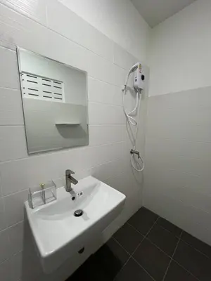 a white bathroom with a sink and a mirror at Karon Beach Villa in Karon Beach