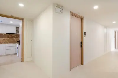 an empty room with a door and a kitchen at The Ozone Condotel Phuket BangTao Beach Spacious 1-BR in Laguna Phuket