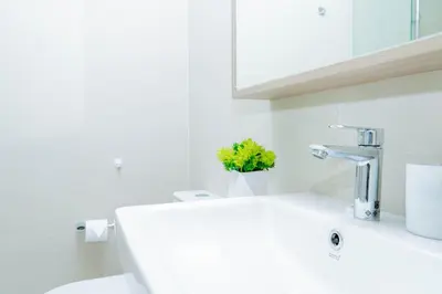 a white bathroom with a sink and a mirror at Laguna Skypark BangTao beach Phuket in Ban Thalat Choeng Thale