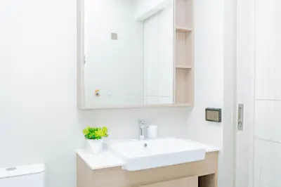 a bathroom with a white sink and a mirror at Laguna Skypark BangTao beach Phuket in Ban Thalat Choeng Thale