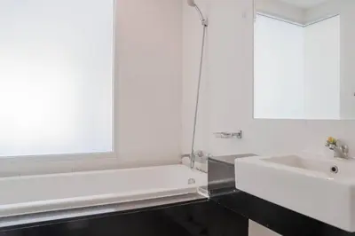 a bathroom with a white tub and a sink at Mountain Loft 700m from Beach [Pool & Gym] in Karon Beach