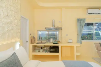 a room with a desk with a sink and a couch at Loft with pool - 8min walk to Rawai Beach - 