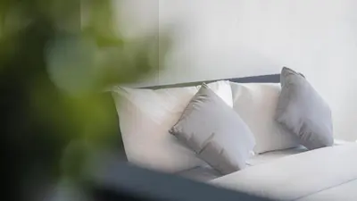 a white bed with four pillows on it at Quiet & Comfy studio near Rawai Beach - 