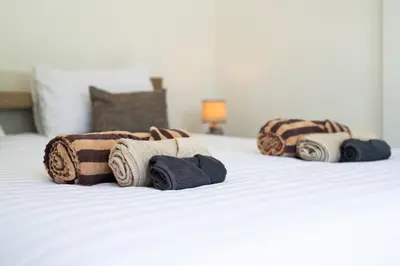 a group of rolled towels on a bed at La Ferme Villa - Modern 3 Bedrooms with Private Pool in Rawai Beach