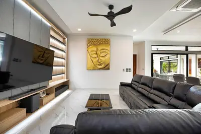 a living room with a couch and a ceiling fan at Palm Villa - Spacious 4 Bedrooms with Private Pool in Rawai Beach
