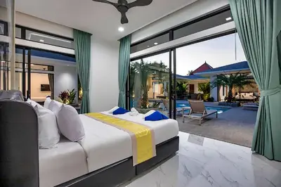 a bedroom with a large bed and a patio at Palm Villa - Spacious 4 Bedrooms with Private Pool in Rawai Beach