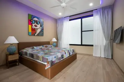 a bedroom with a bed and a painting on the wall at Pattana Moon - Luxury Calm 4 Bedrooms Pool Villa in Ban Saiyuan (1)