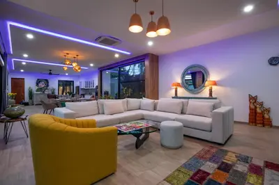 a living room with a white couch and yellow chairs at Pattana Moon - Luxury Calm 4 Bedrooms Pool Villa in Ban Saiyuan (1)