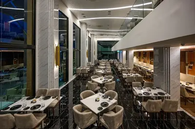 a row of tables and chairs in a restaurant at Deluxe Surin apartment with washer and fast WIFI in Surin Beach