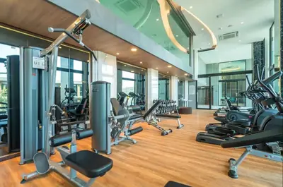 a gym with a bunch of treadmills and machines at Deluxe Surin apartment with washer and fast WIFI in Surin Beach