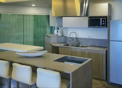 a kitchen with a table with white chairs and a sink at Karon beach Stylish large 2BR with Sea View in Karon Beach