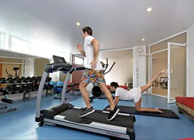 a man and a woman on a treadmill in a gym at Karon beach Stylish large 2BR with Sea View in Karon Beach