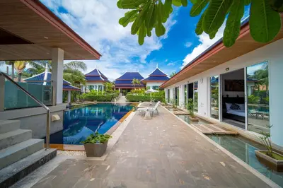 an external view of a house with a swimming pool at Luxurious 8bedroom villa in Bangtao Large private pool Group vacation villa Free maid and private kitchen service Extended in Bang Tao Beach