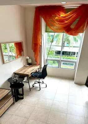 a room with a desk and a large window at Veloche group in Karon Beach