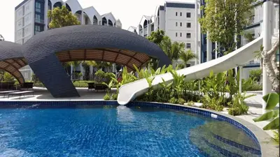 a water slide in a resort with a pool at Title HALO 1 - Modern 1BR Pool View Walk to Nai Yang Beach in Nai Yang Beach