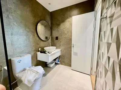 a bathroom with a toilet and a sink and a mirror at Title HALO 1 - Modern 1BR Pool View Walk to Nai Yang Beach in Nai Yang Beach