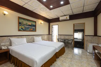 a bedroom with a large bed in a room at Kata Palace Phuket Hotel in Kata Beach