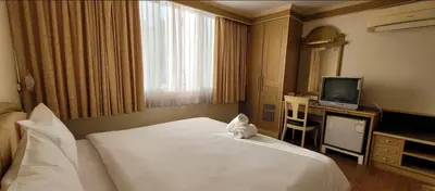 a hotel room with a bed and a television at Neptuna Kata Beach in Kata Beach