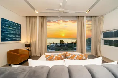 a living room with a couch and a large window at The bay Cape Yamu Villa 10 in Phuket Town