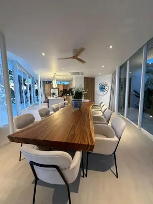 a dining room with a wooden table and chairs at The bay Cape Yamu Villa 2 in Ko Lek
