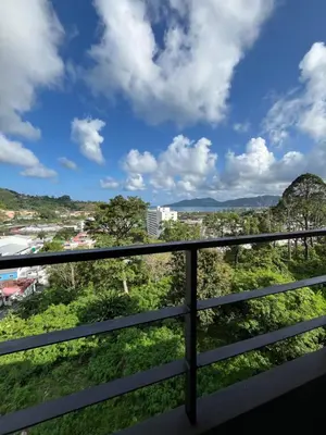 a view of the city from a balcony of a building at Hill Bay Suites Hotel in Patong Beach