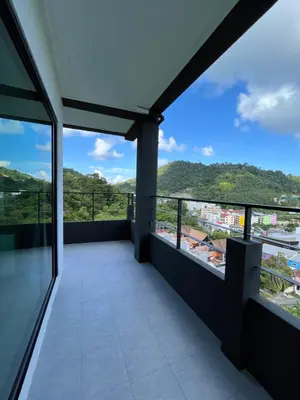 a balcony with a view of the mountains at Hill Bay Suites Hotel in Patong Beach
